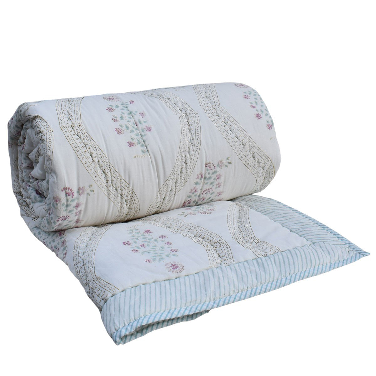 A rolled-out quilted bedding set featuring a cream-colored top layer with a delicate pink and green floral pattern, light blue and white striped borders, and matching striped piping.