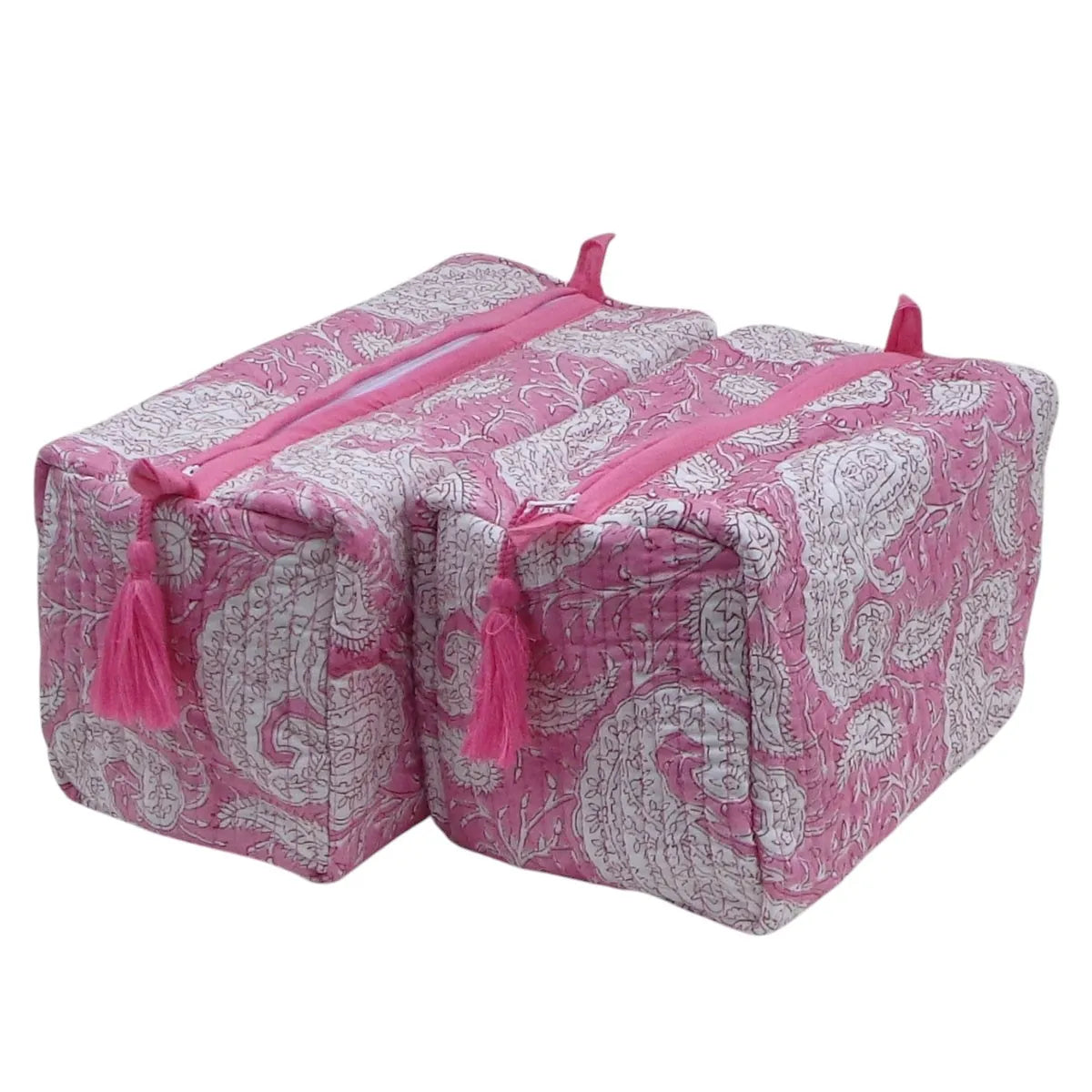 Two pink and white paisley patterned quilted storage bags with pink zipper pulls and tassels, shown on a plain white background.