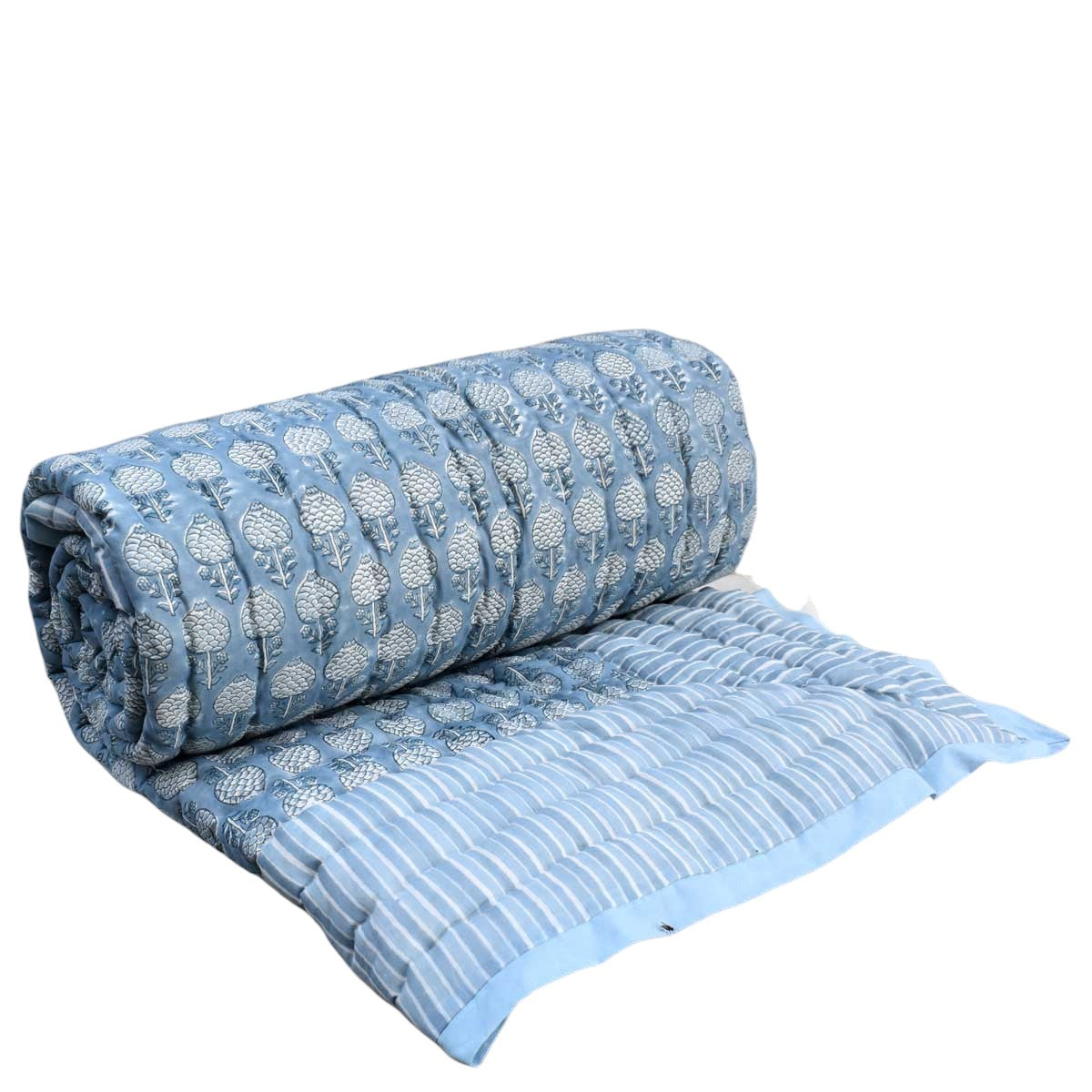 A light blue quilted blanket with a white floral pattern on the rolled section and white stripes on the flat section, shown on a white background.