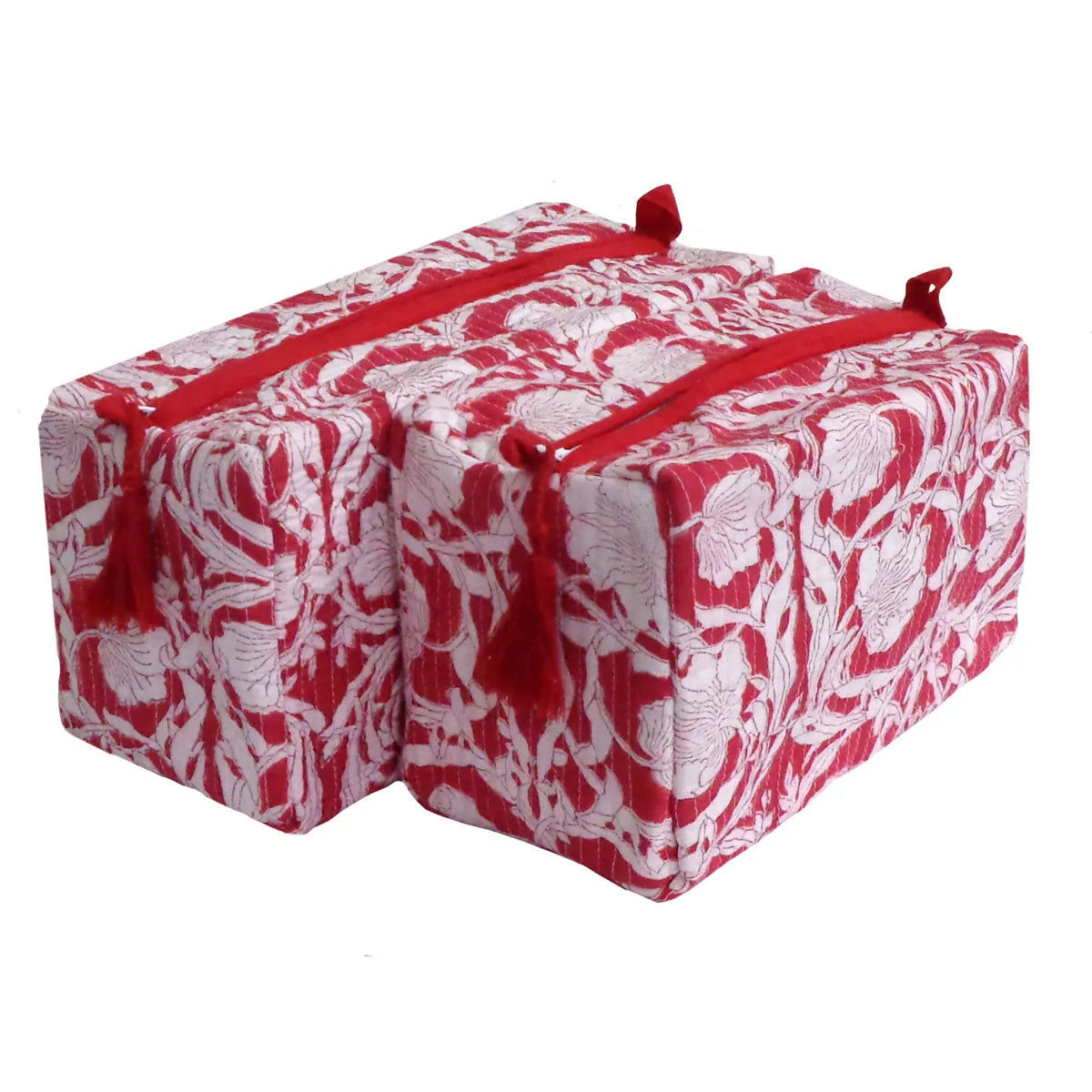 Two rectangular red and white floral patterned yoga blocks with red tassels and straps, displayed on a clean white background.
