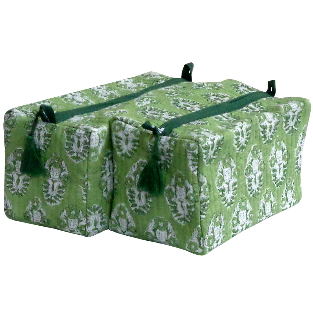 Two rectangular yoga props or cushions with a green and white floral damask pattern, featuring dark green straps and tassels, shown on a plain white background.