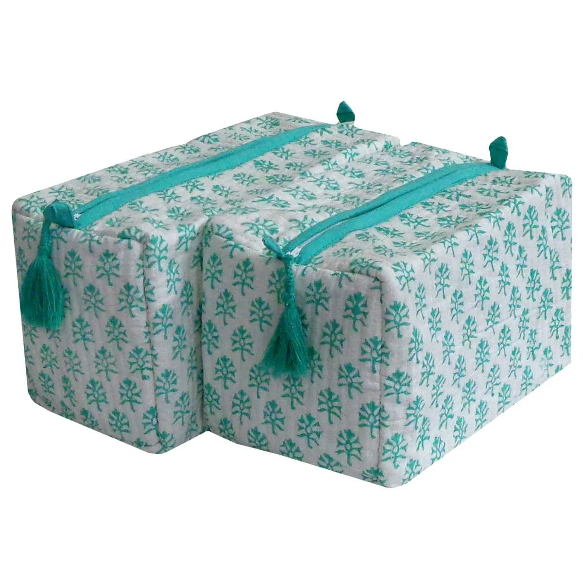 Two square yoga props or storage boxes with a white fabric cover featuring a teal floral pattern, a teal zipper, and matching teal tassels, shown on a plain white background.