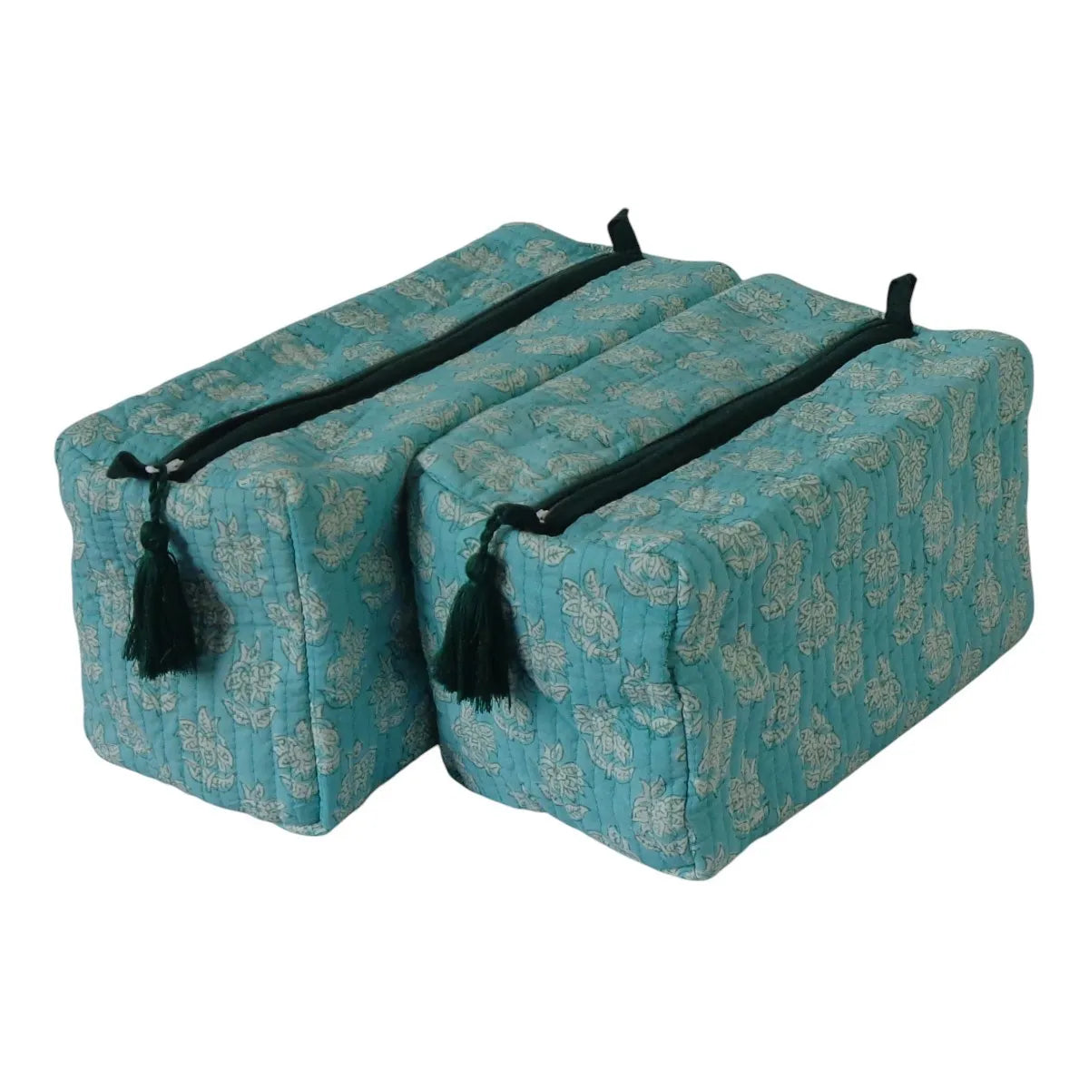 Two rectangular yoga props with quilted teal-blue fabric and a beige paisley pattern, featuring black straps and tassels, shown on a white background.