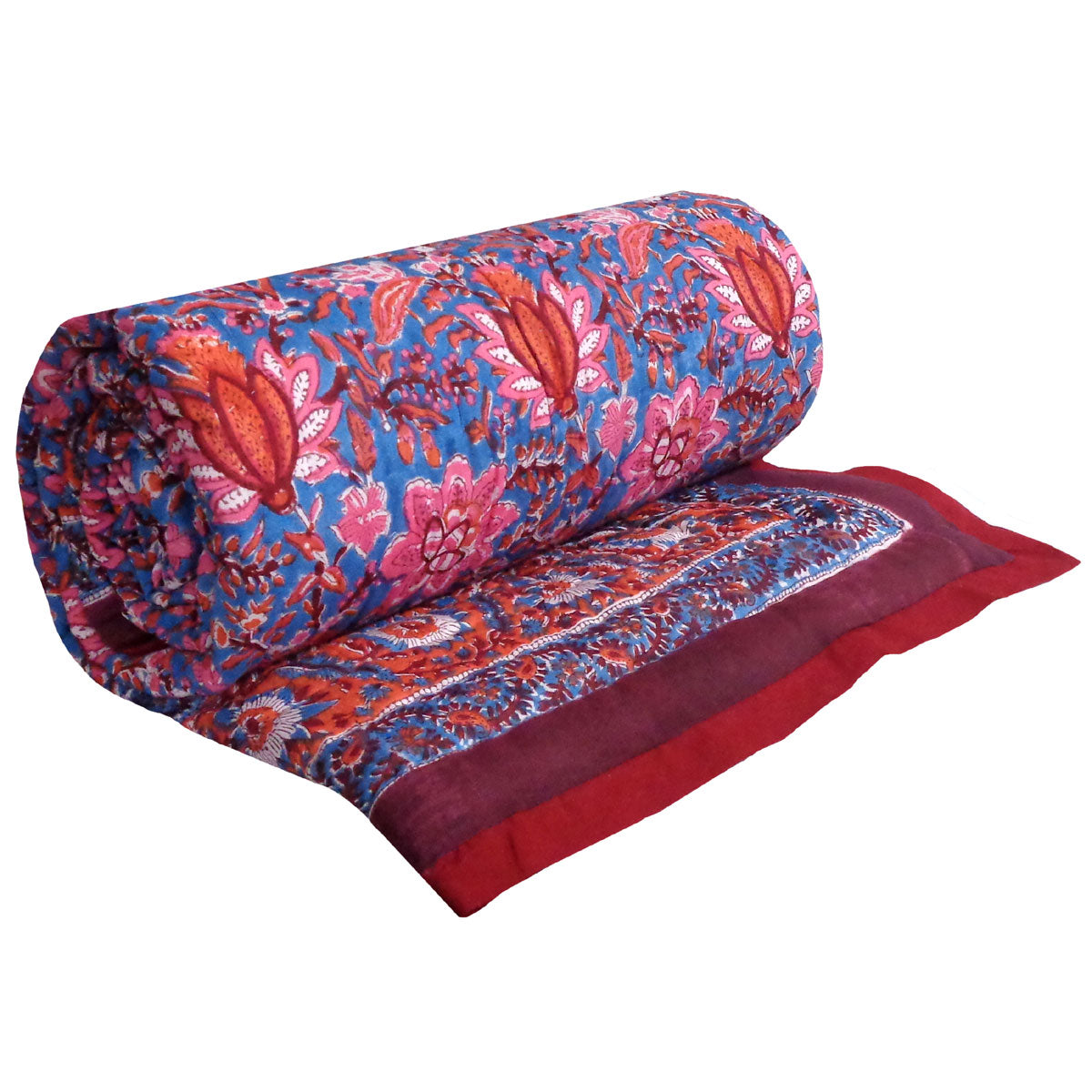 A rolled-up patterned fabric piece, likely a quilt, throw, or scarf, featuring a blue base with pink and red floral motifs and a solid red border, shown on a plain white background.