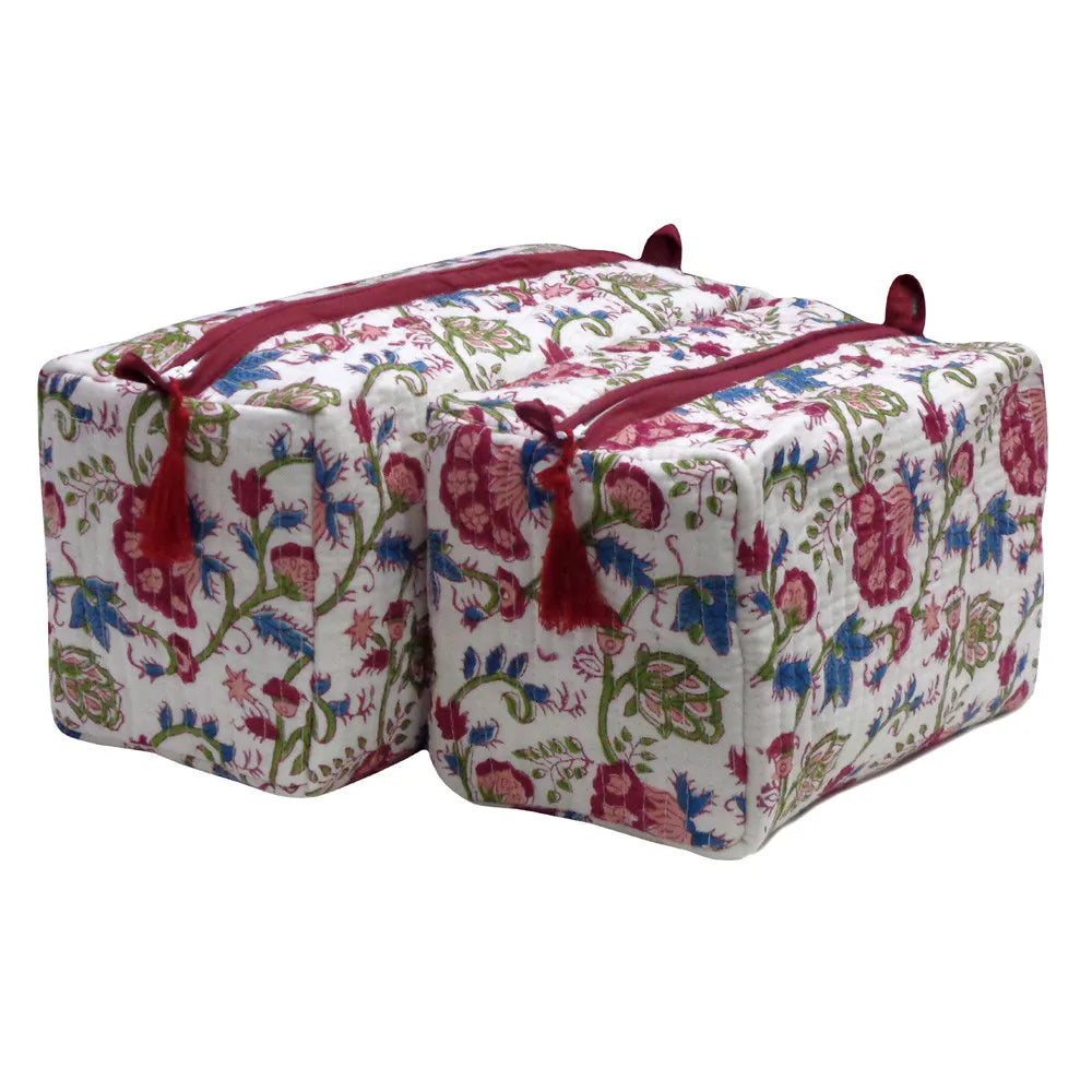 Two square yoga props or storage bags with a white background and a colorful floral print in pink, blue, and green, featuring red zipper pulls and tassels.