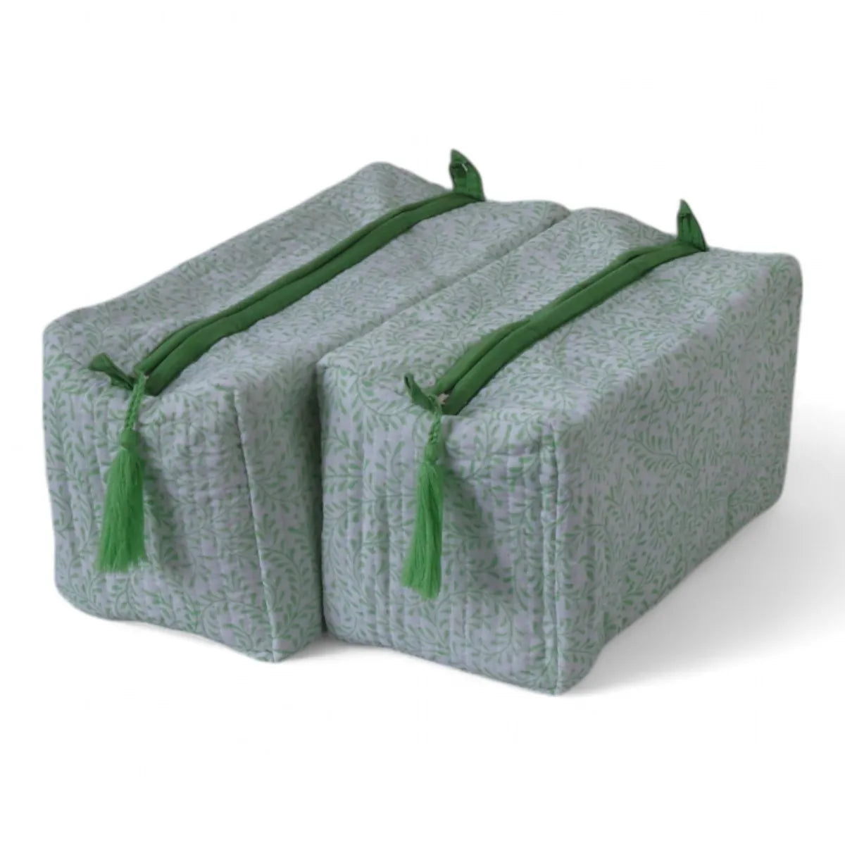 Two rectangular yoga props or foam blocks with a light sage green and white patterned fabric cover, featuring green drawstrings and tassels, shown on a white background.