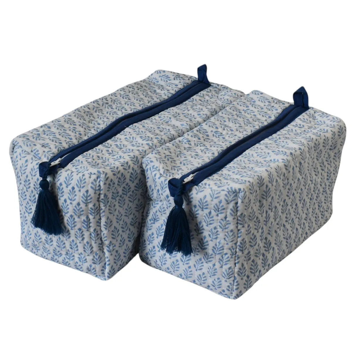 Two rectangular zippered storage bags with a blue and white leaf pattern, featuring dark navy blue tassels and handles, shown on a plain white background.
