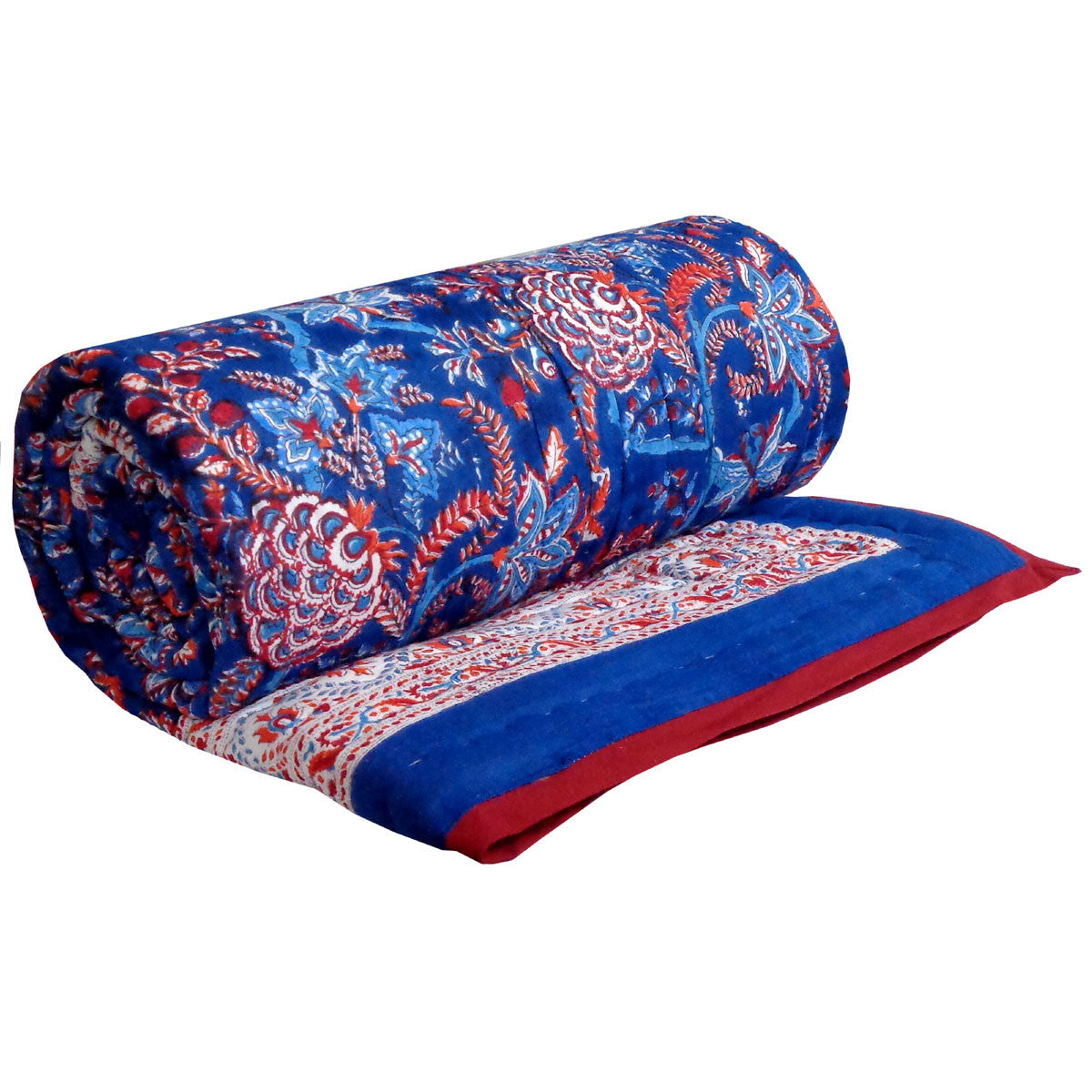 A patterned quilted comforter in navy blue, red, and white, styled on a bed with white pillows in a bedroom setting.