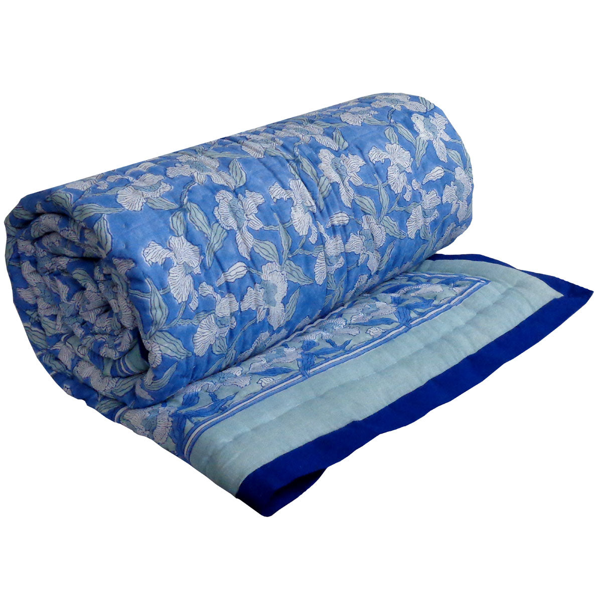 A light blue and white patterned quilted bedspread with matching shams and striped pillows, styled on a bed in a bright, modern bedroom with light blue patterned wallpaper and wooden nightstands.