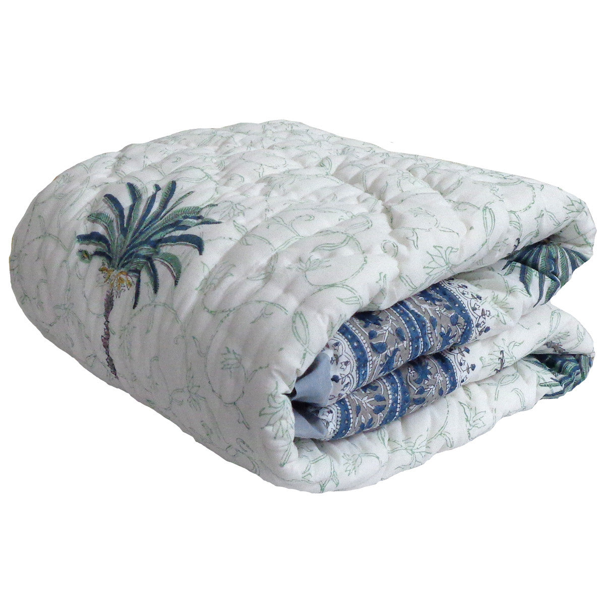 A folded quilted blanket with a white background, featuring a blue and green palm tree design on the front and a blue patterned inner side, shown against a plain white background.