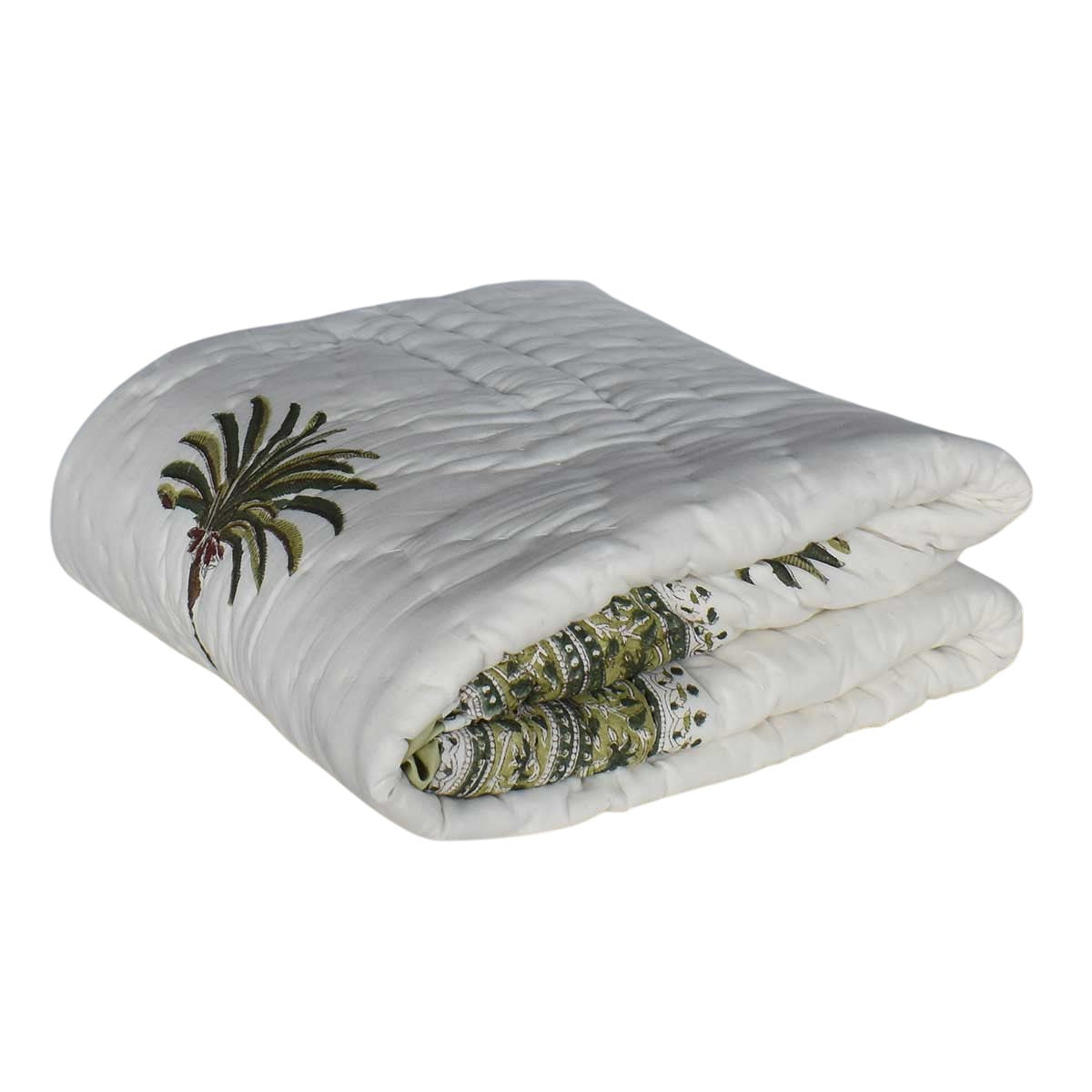 A folded white quilted blanket featuring embroidered green palm leaves and a patterned green and black border, shown on a plain white background.