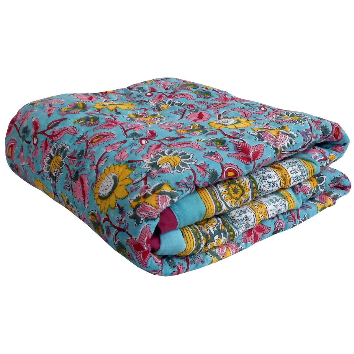A folded cotton quilt or comforter featuring a vibrant floral and paisley block print on a turquoise blue background, with yellow, pink, red, and white patterns.