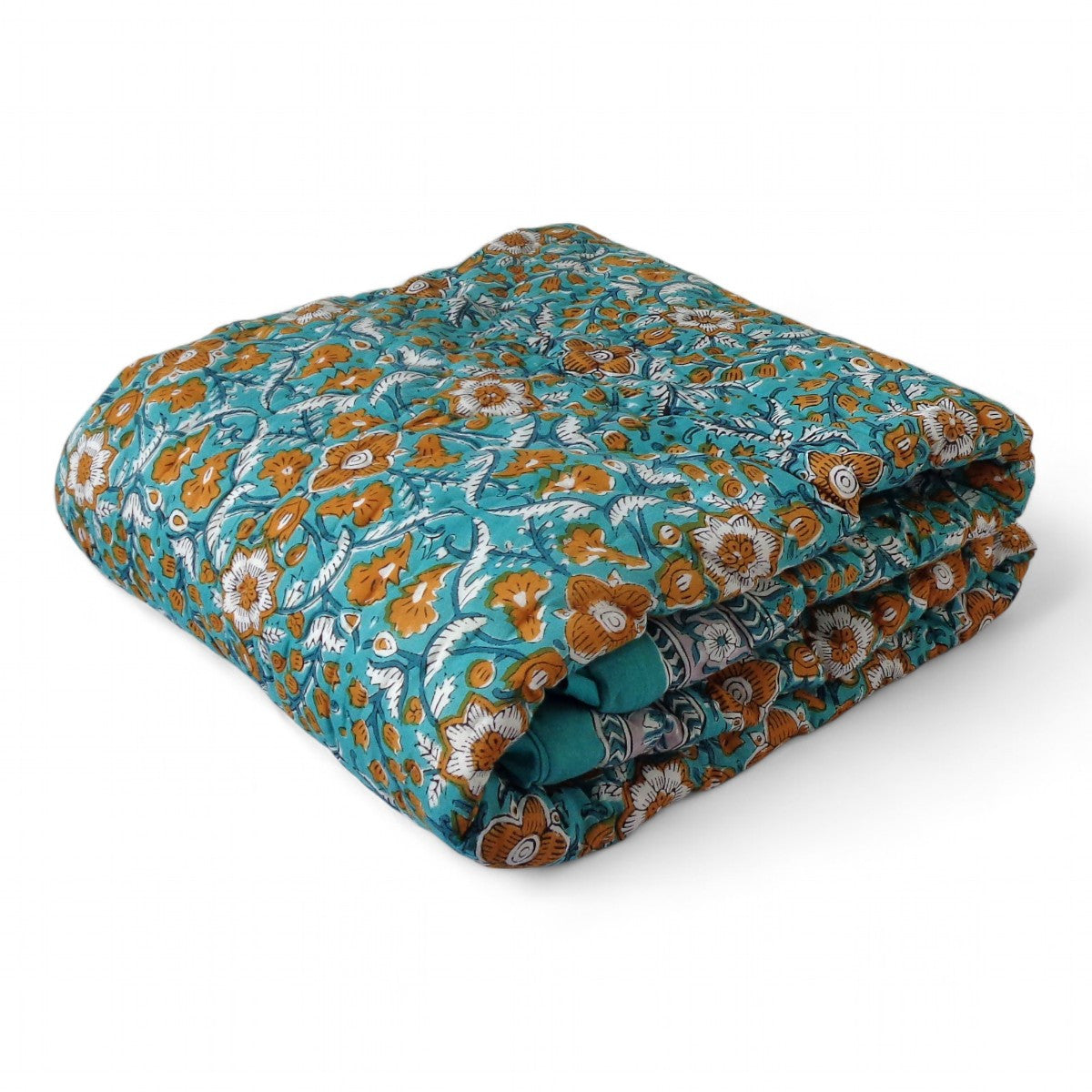 A folded quilted blanket featuring a vibrant teal blue background with an intricate orange, white, and brown floral block-print pattern, shown on a clean white background.