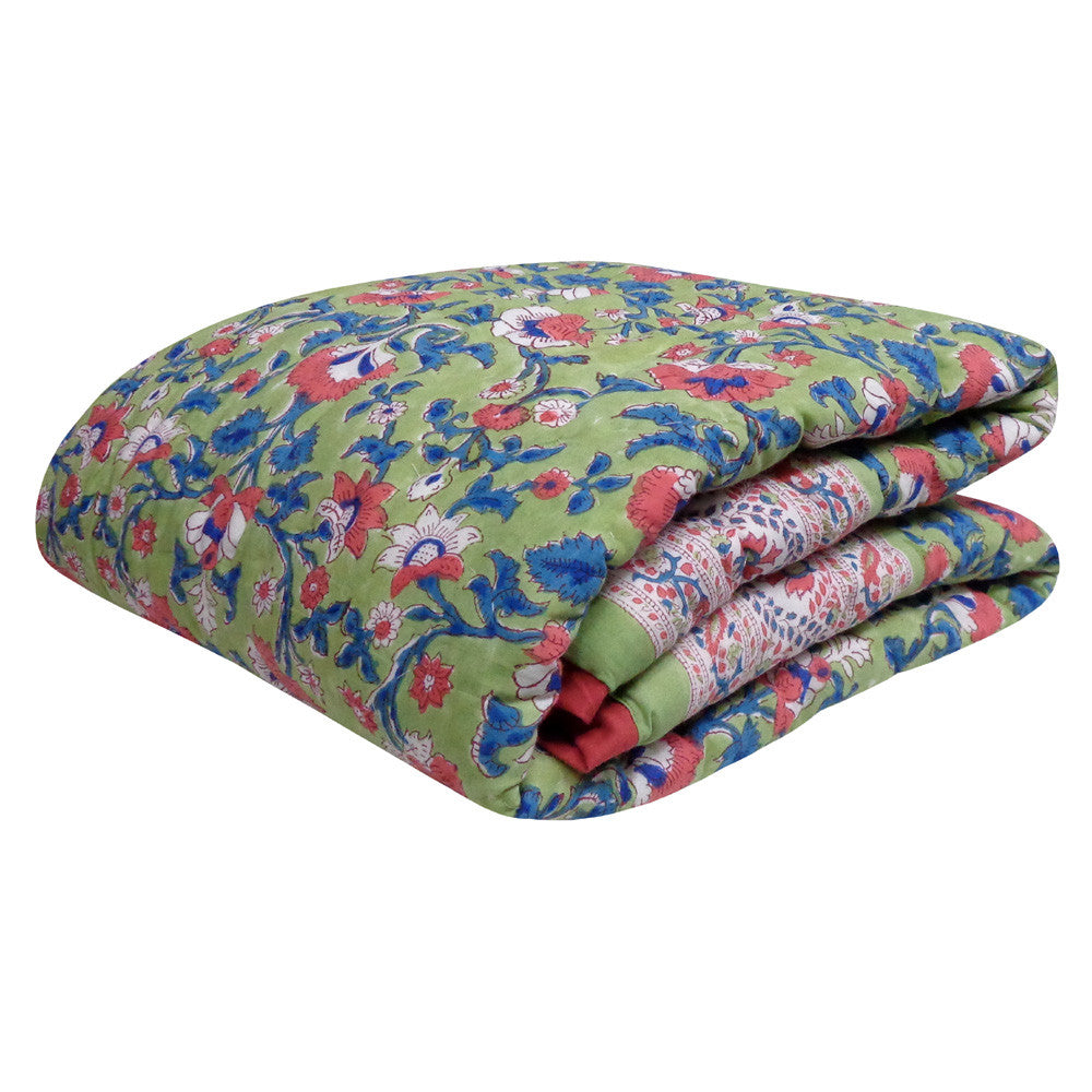 A folded quilted comforter with a vibrant green base and a dense floral pattern in red, blue, and white, shown against a plain white background.