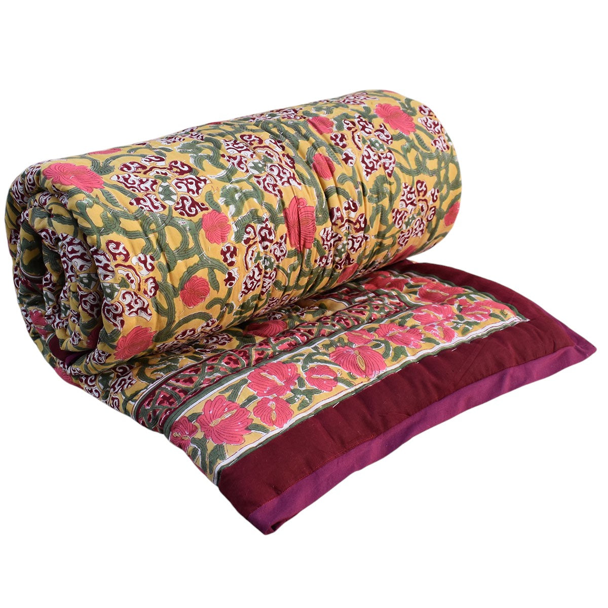 A rolled and laid-flat quilted blanket with a vibrant floral and paisley pattern in pink, green, and yellow, featuring a solid deep purple border.