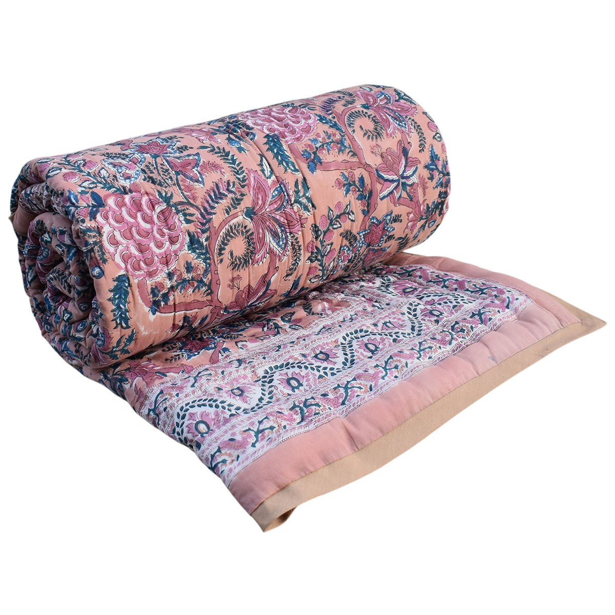 A rolled-up quilted blanket with a pink floral and paisley pattern, shown partially unrolled to display its pattern and solid pink border on a white background.
