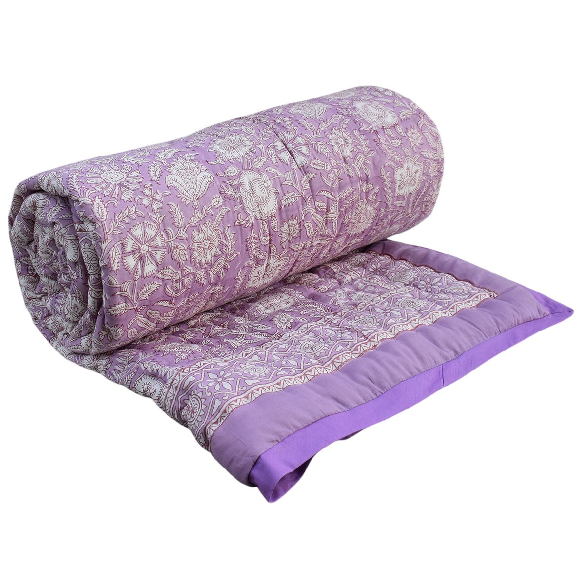 A lavender purple quilted comforter with a white floral pattern and matching purple piping, shown rolled up with part of the flat side displayed against a plain white background.