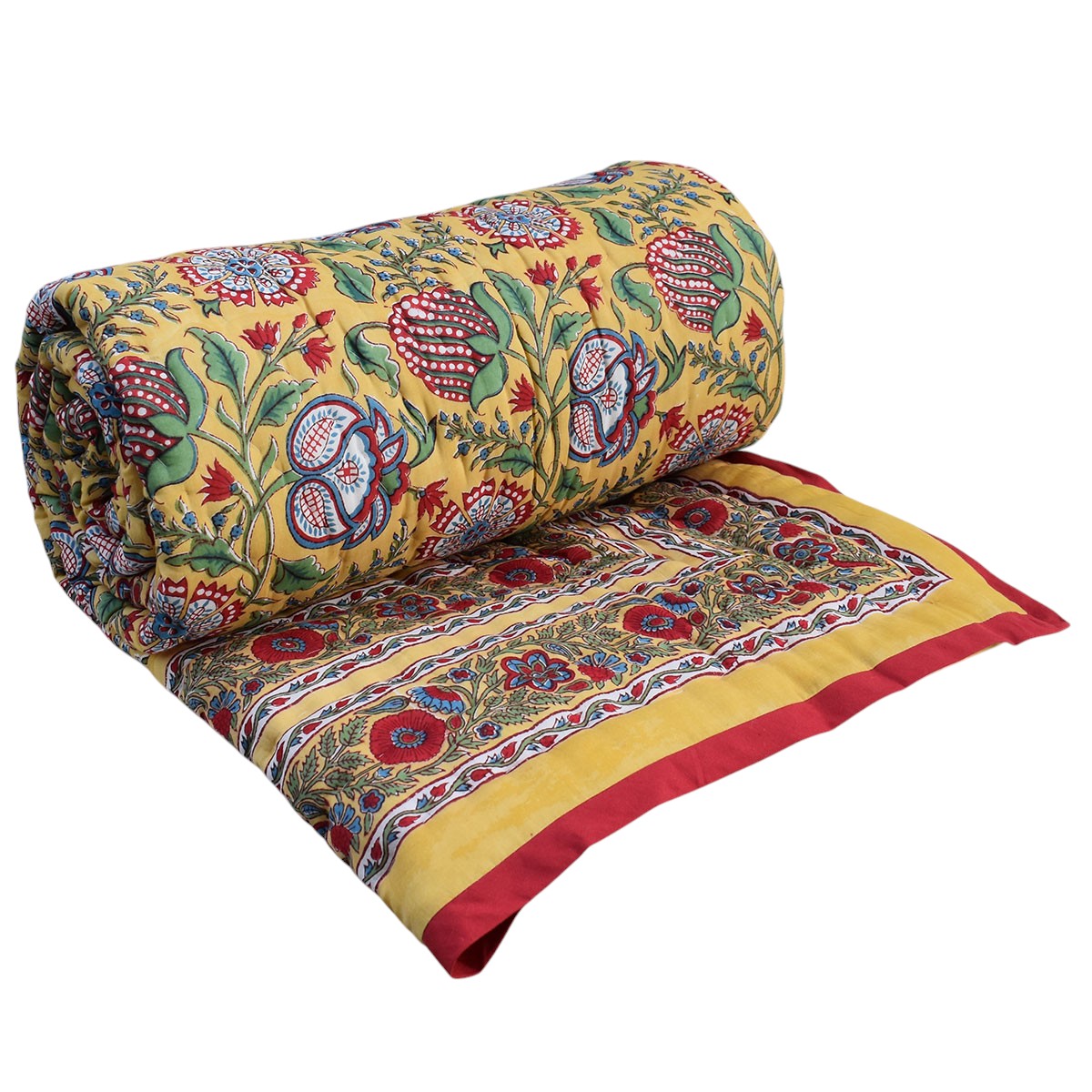 A rolled and partially unrolled yellow patterned textile, likely a quilt, blanket, or throw, featuring a colorful floral and paisley print with red, green, blue, and purple motifs and a red border, shown on a plain white background.