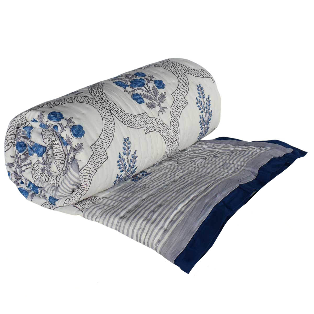 A rolled and partially unrolled quilted blanket featuring a blue and gray floral and scroll pattern on a white base, with a solid navy blue striped border.