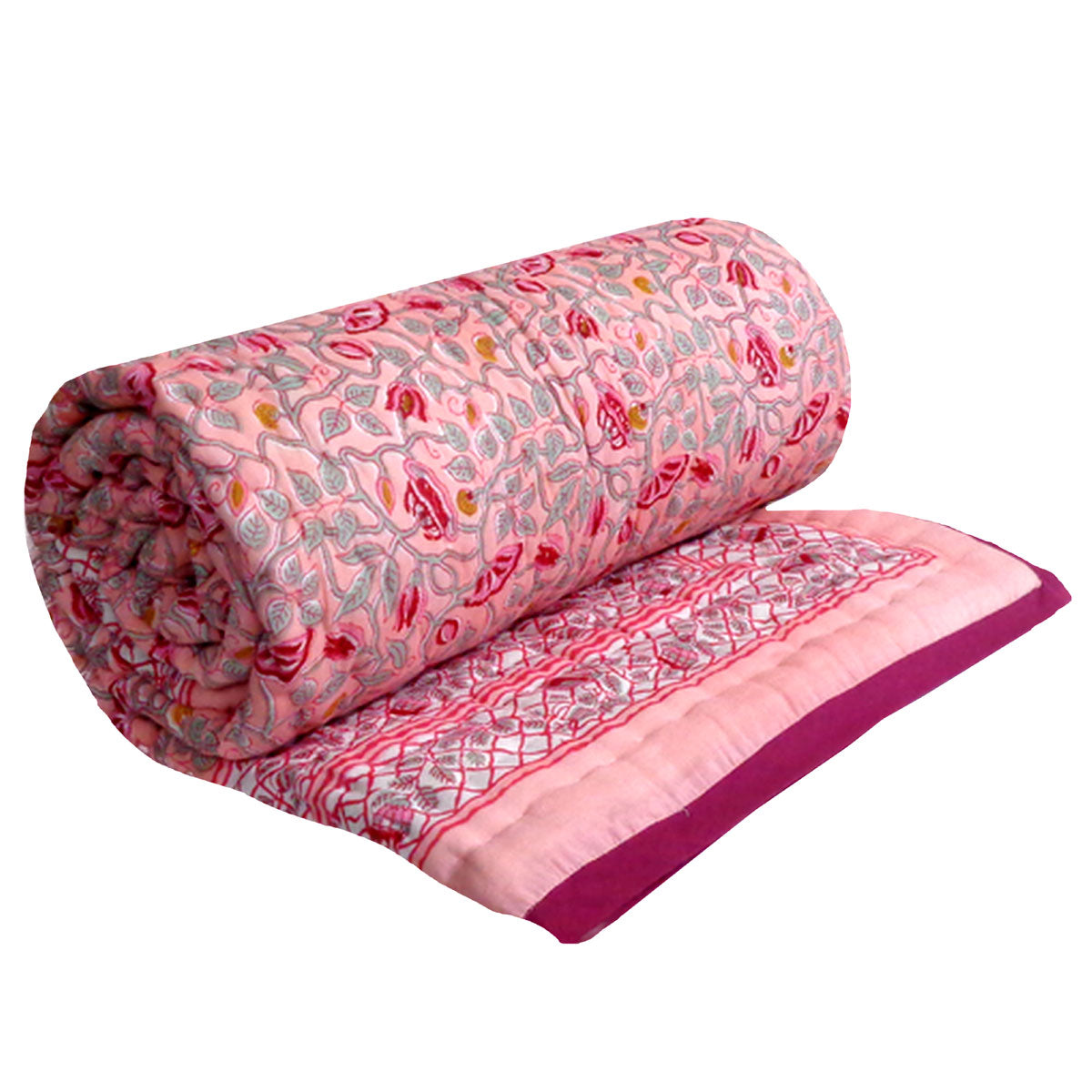 A rolled-up pink quilted blanket with a floral and paisley pattern, shown partially unrolled to display its patterned border and solid magenta edge, set against a plain white background.